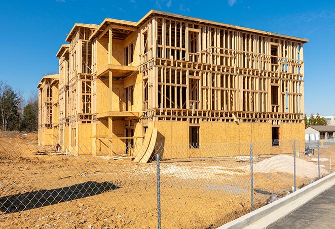 a temporary chain link fence locking away a building under renovation, serving as a security tool in Wellsville, KS